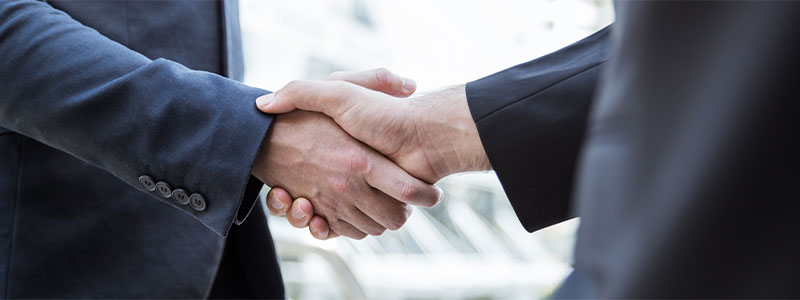 business broker shaking hands with client