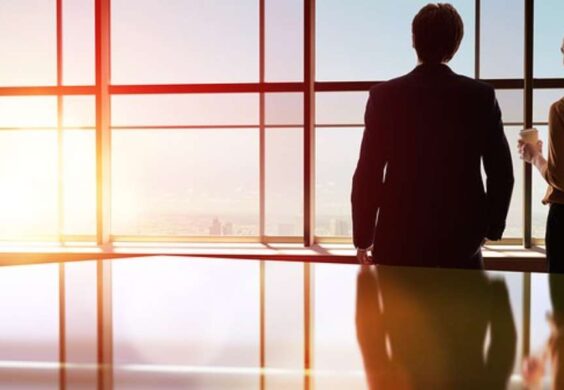 business woman and man looking outside of a window