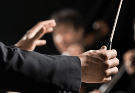 orchestra conductor leading performance