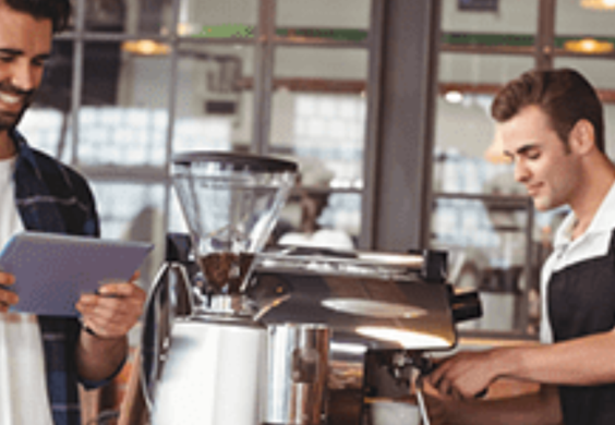 cafe workers preparing coffee and looking at orders