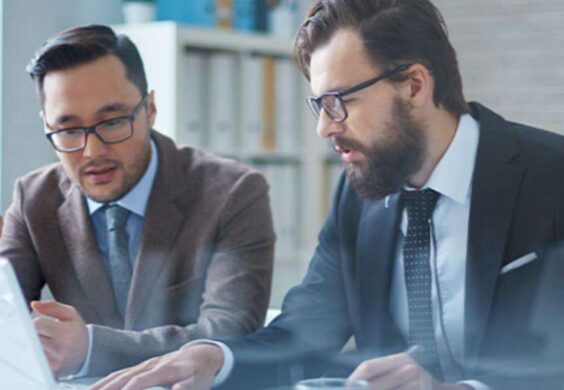 business people looking at laptop