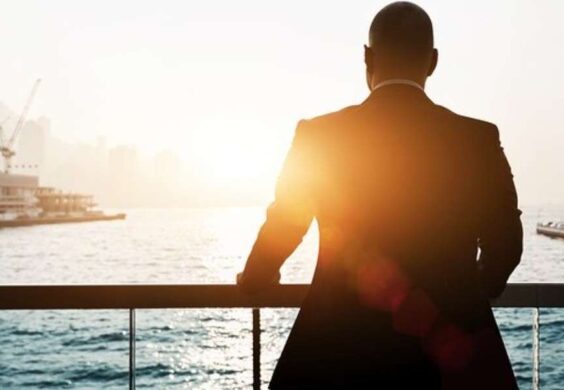 business man looking out at water