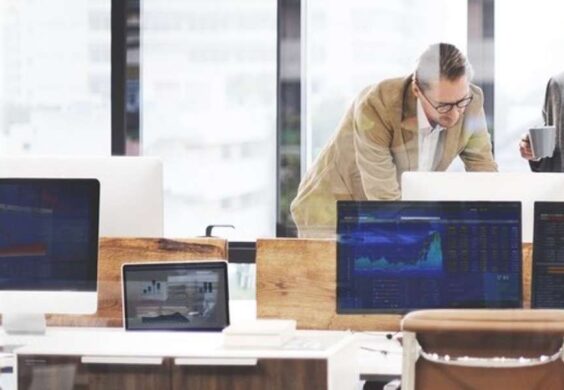 colleagues reviewing computer presentation