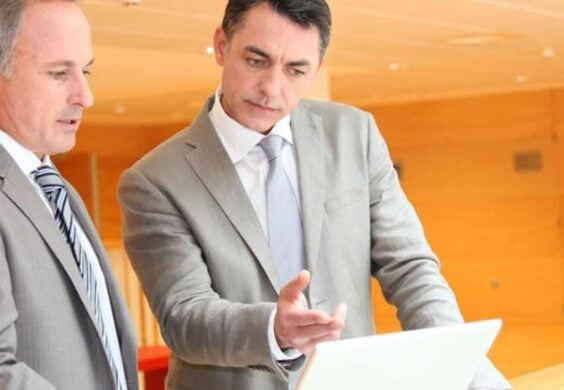 business men looking at laptop