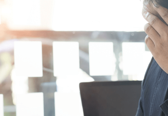 man holding his head in his hand