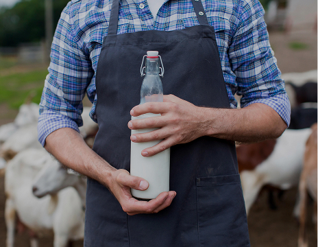 farmer holding vase of milk