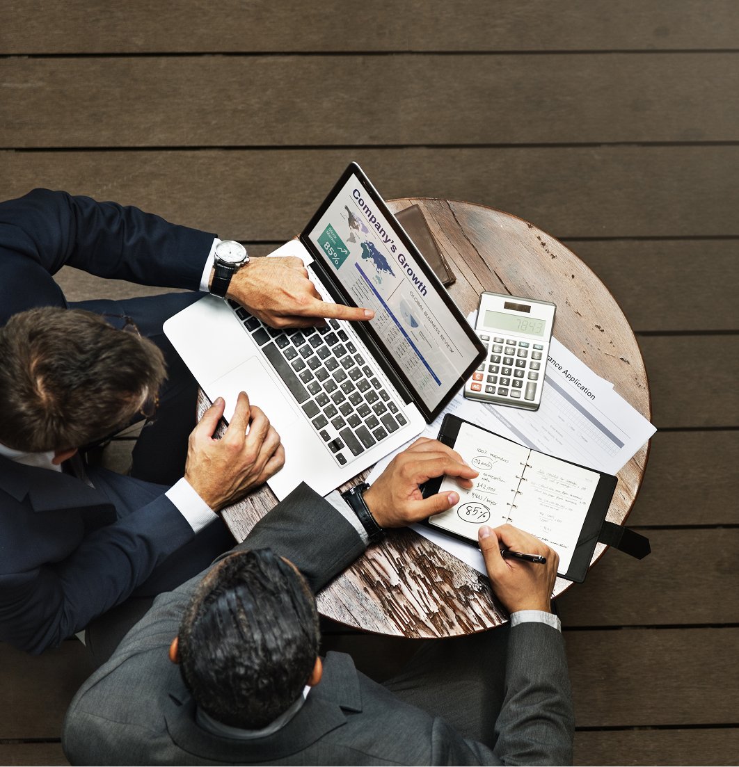 business men reviewing notebook and laptop