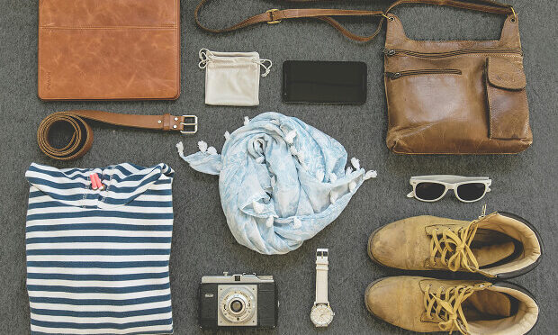 camera, hiking boots, wallet, purse and other travel gear