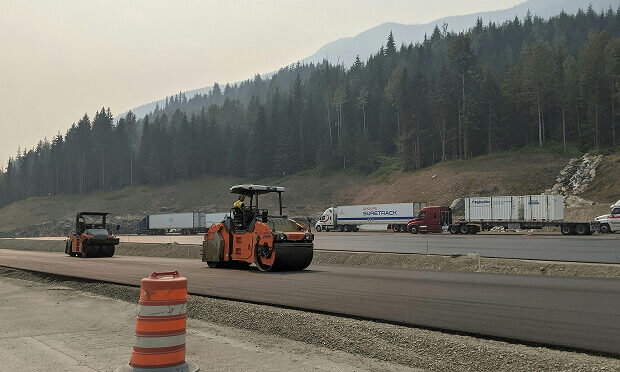 asphalt pavement machine on top of fresh pavement