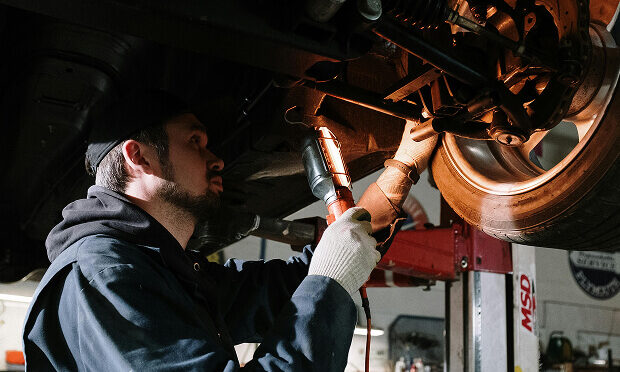 man fixing car tire