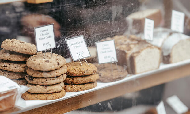cookies and other baked goods inside cafe shelves