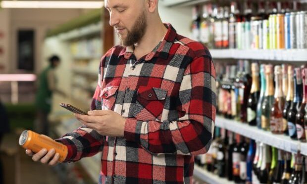 man scanning drink inside of beer and wine store