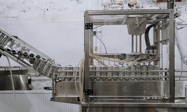 beverage manufacturing machine moving products along conveyor belt