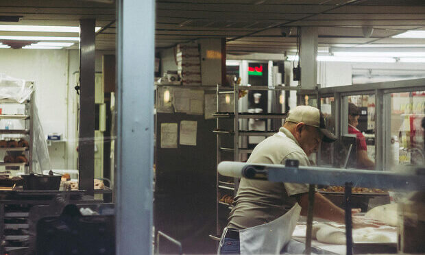 man preparing dough inside commercial kitchen