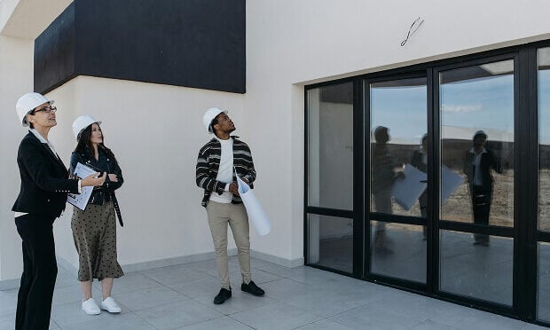 building inspectors looking at exterior of property