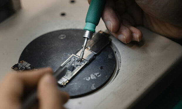 person inspecting device's hard drive