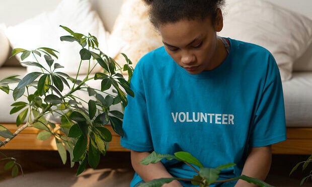 woman planting potted plant