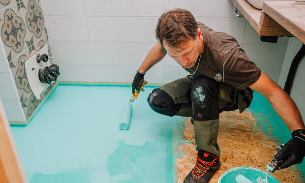 man painting over bathroom floor