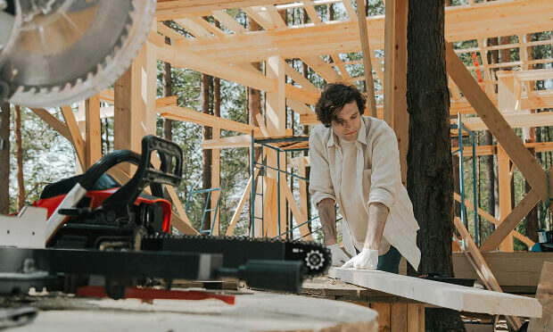 man working on piece of lumber