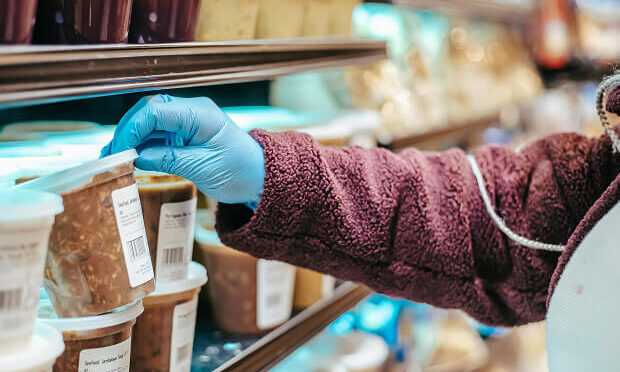store clerk inspecting soup containers