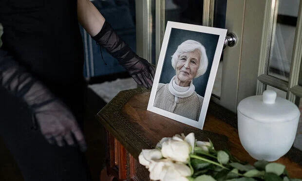 woman looking at photo inside of funeral home