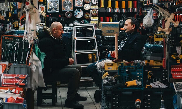 men sitting inside hardware store