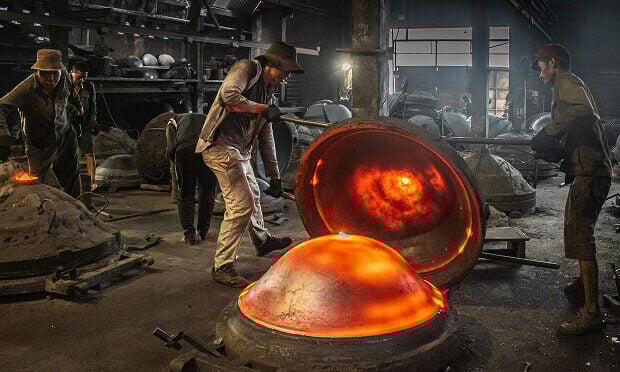 workers covering burning pod