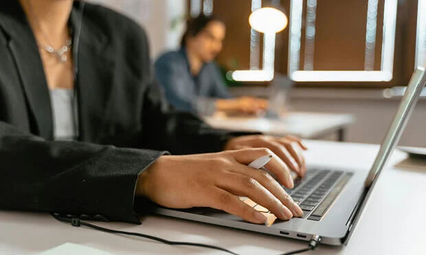 business woman typing on laptop