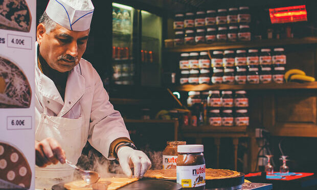 pastry chef spreading nutella on crepe
