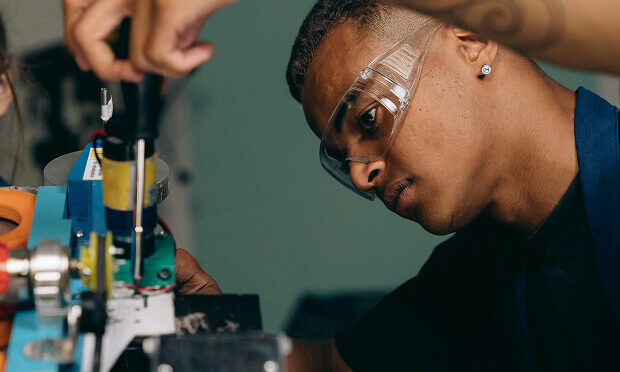 man fixing electronic equipment
