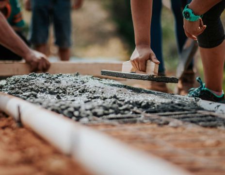 workers smoothing poured concrete