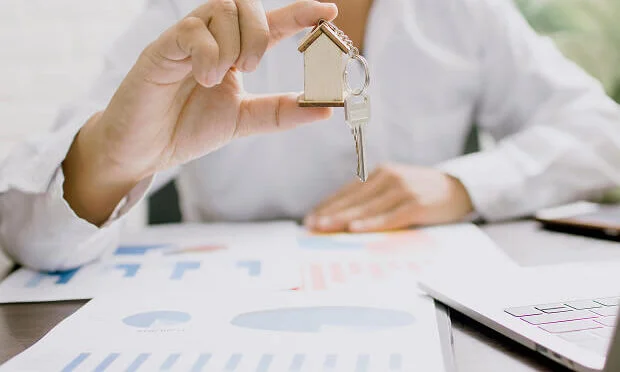 man holding key to new home