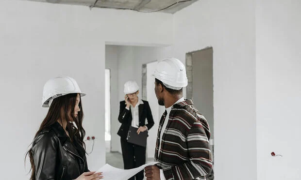 people reviewing blueprint of home
