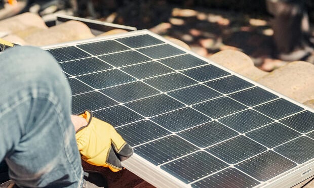 man laying solar tile