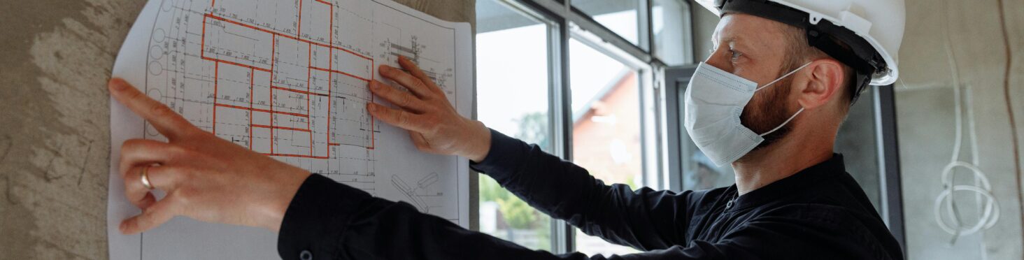 man reviewing print-out of layout of home