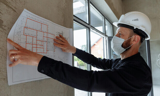 man reviewing print-out of home layout