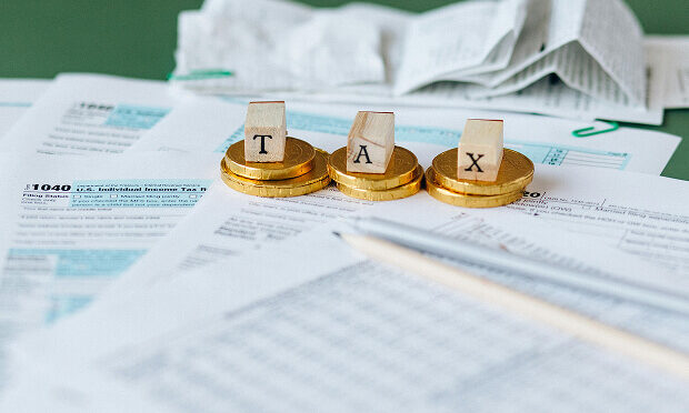 coins and blocks stacked on top of tax documents