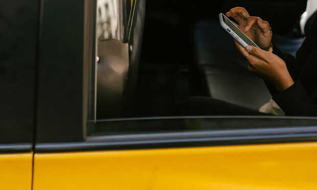 man texting from phone inside a cab