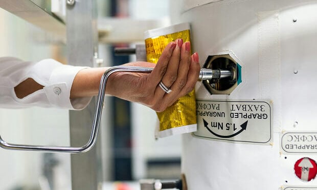 woman placing valve inside testing machine