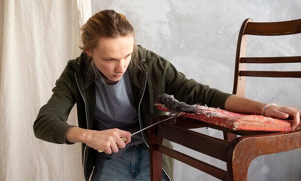 woman removing old covering off dining table seat