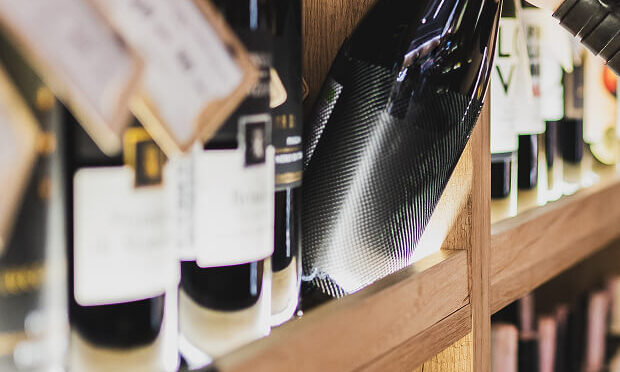 woman pulling wine bottle off the shelf