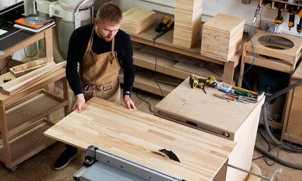 man building cabinet in woodwork shop